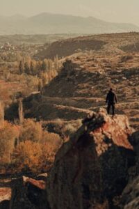 Autumn view of İncesu, Kayseri with a lone figure, capturing the rugged terrain and vibrant fall foliage.