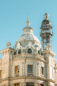 Elegant Art Nouveau facade of Valencia's historic post office building under a clear blue sky.